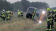 Firefighters are standing next to a long-distance bus on the A24 motorway in Woebbelin, northern Germany.