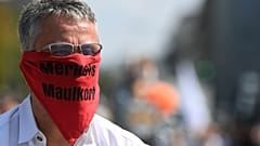 A participant at a demonstration against COVID-19 restrictions wears a scarf reading 'Merkel's muzzle', Munich, Germany. September 12, 2020. 