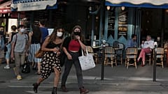 People, wearing a protective face mask as a precaution against the coronavirus, walk in Paris, Thursday Sept. 10, 2020.