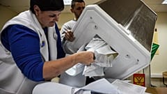 Members of a local electoral commission empty a ballot box at a polling station in Siberian city of Novosibirsk, on September 13, 2020. 