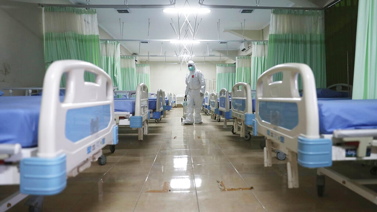 A medics inspects makeshift isolation rooms in Indonesia