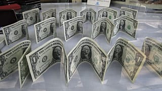 US dollars decorate a foreign currency exchange bureau, in Ferdowsi St. in downtown Tehran, Iran