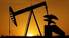  A pumpjack is silhouetted against the setting sun in Oklahoma City
