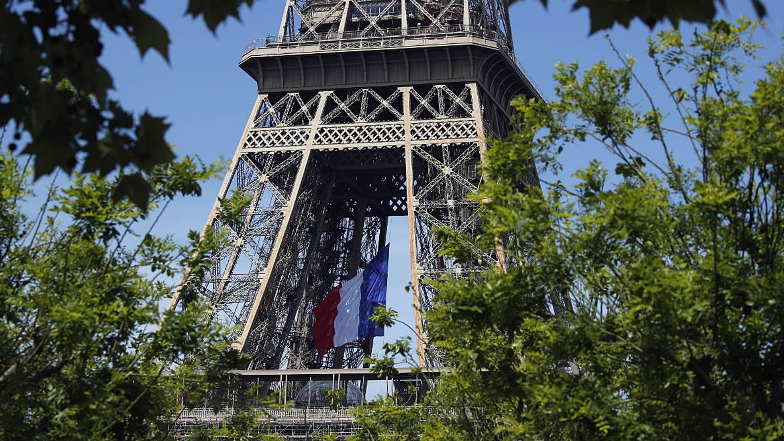 The French national flag decorates the Eiffel Tower