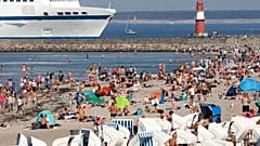 People enjoy the unusually warm late summer weather on the Baltic Sea beach  in Warnemuende, Germany