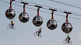Performers dressed as riders pedal during the start of stage 17 of the Tour de France cycling race over 170 kilometres, starting in Grenoble. September 16, 2020
