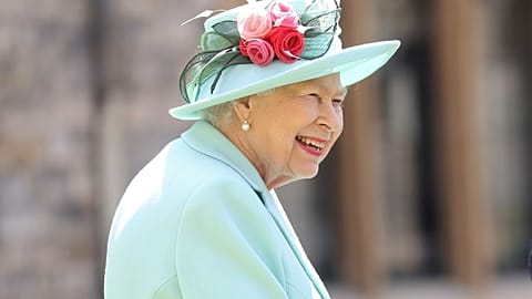 n this July 17, 2020 file photo, Britain's Queen Elizabeth smiles after awarding Captain Sir Thomas Moore his knighthood during a ceremony at Windsor Castle in England.