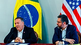 U.S. Secretary of State Mike Pompeo speaks as Brazilian Foreign Minister Ernesto Araujo looks on during a press conference at the Boa Vista Air Base in Roraima, Brazil