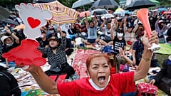 Pro-democracy activities shout slogans during a protest at Thammasat University in Bangkok, Thailand, Saturday, Sept. 19, 2020.