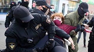 Police officers detain a woman during an opposition rally in Minsk on September 19, 2020.