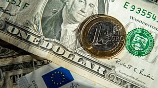This file photo taken on January 17, 2015 shows euros and US dollar bills taken in Godewaersvelde, Northern France.