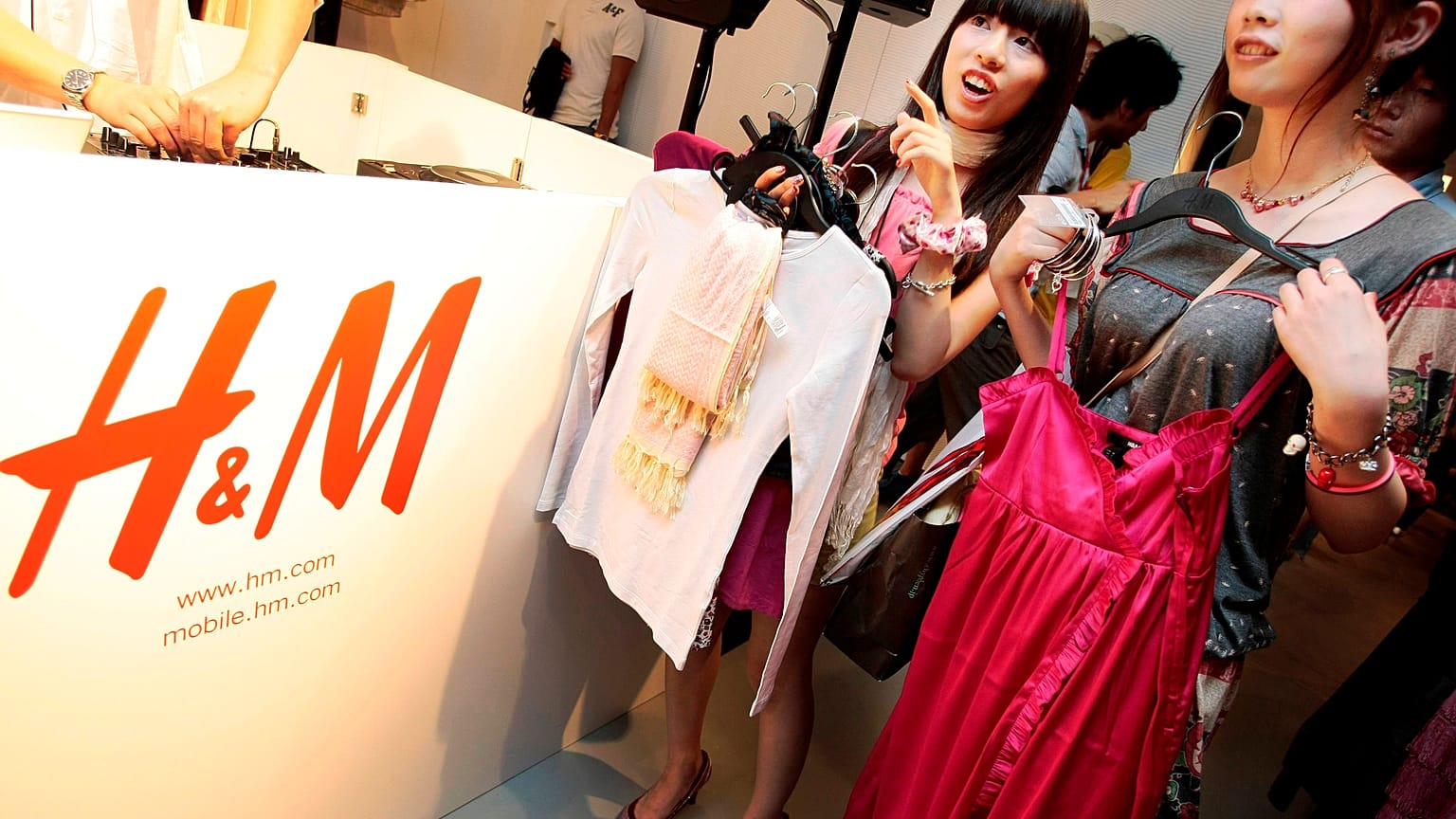 FILE: Shoppers on opening day of H&M's first Japan store in Tokyo's Ginza shopping district examine clothes, Sept. 13, 2008. 
