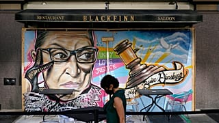 A mural in remembrance of Supreme Court Justice Ruth Bader Ginsburg covers plywood outside Blackfinn Ameripub, Monday, Sept. 21, 2020, in Washington.