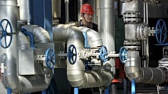 A Chinese worker walks past equipment at an oil refinery of the PetroChina