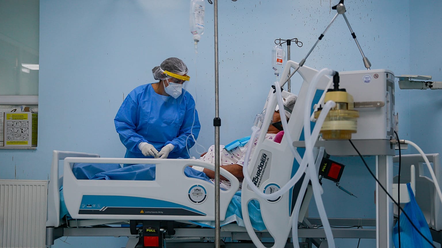 A nurse inside the Intensive Care Unit attends to a patient with COVID-19 in the Clinic for Infectious Diseases, in Pristina, Kosovo, Sept. 21, 2020.