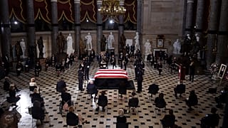 A U.S. Capitol Police honor guard surrounds the flag-draped casket of Justice Ruth Bader Ginsburg as lies in state in Statuary Hall of the U.S. Capitol, Friday, Sept. 25, 2020