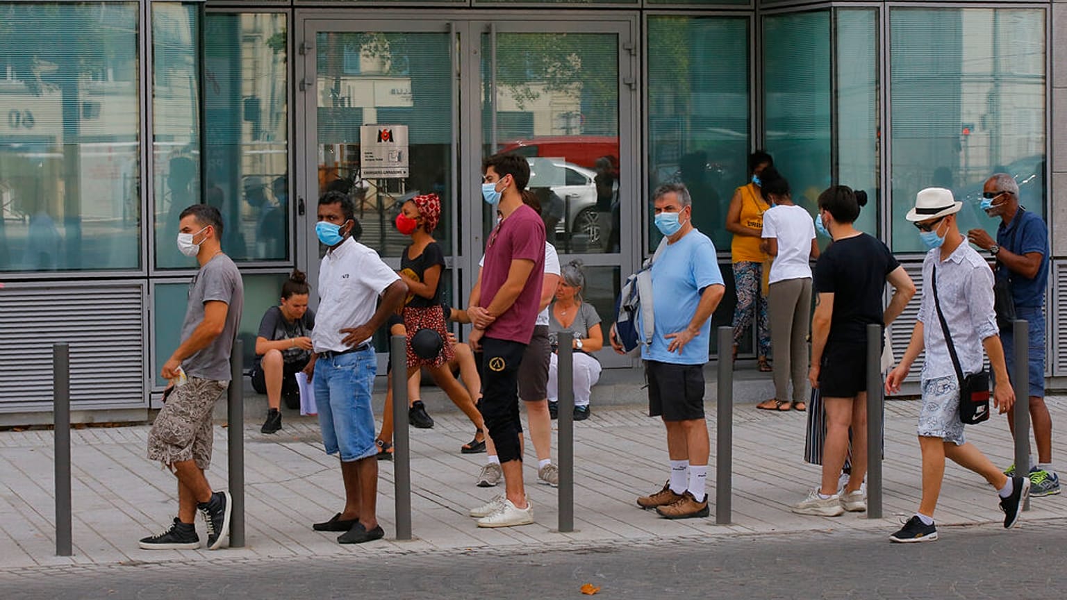 People wait in a line to get tested for COVID-19 outside a laboratory in Paris, Saturday, Aug 8, 2020. 