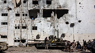 In this Sept. 22, 2016 file photo, fighters of the Libyan forces affiliated to the Tripoli government rest and reload weapons during an offensive against Islamic State.