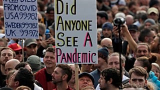 People take part in a 'We Do Not Consent' rally at Trafalgar Square, organised by Stop New Normal, to protest against coronavirus restrictions, in London, Saturday, Sept. 26.