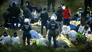 Activists are surrounded by police on the Garzweiler power plant grounds in Grevenbroich, western Germany, Saturday, Sept. 26, 2020.