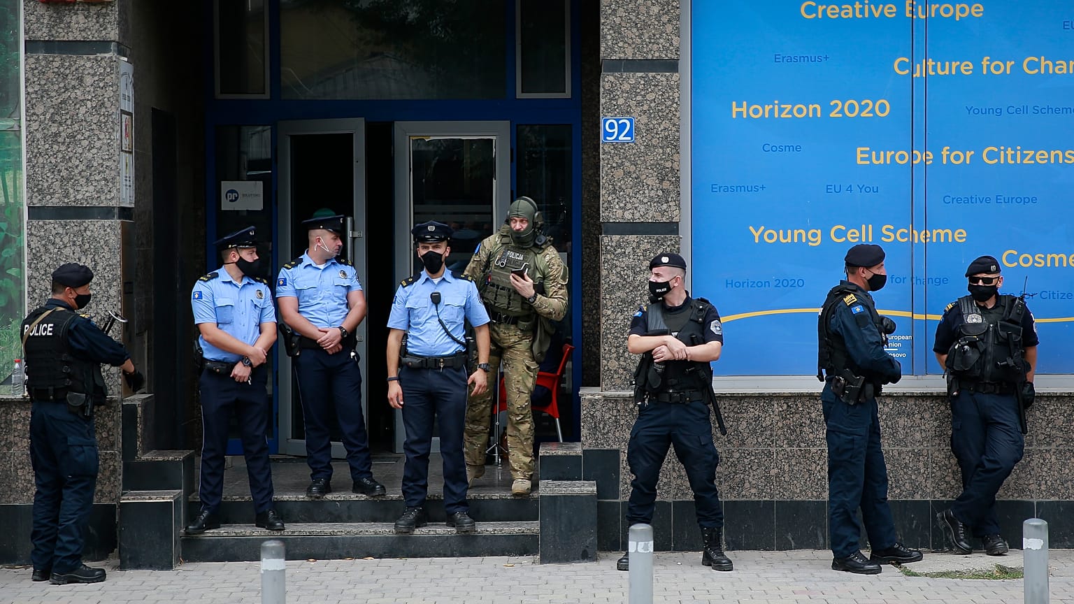 Kosovo police guard the entrance of the offices of a war veterans association in Kosovo, in Pristina.