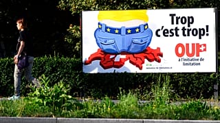 FILE - Aug. 27, 2020 - A poster of the Swiss People's Party (SVP) on immigration reading ''Enough is enough!'' is displayed in Lausanne, Switzerland.