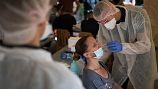 A woman is tested for COVID-19 at a mobile testing center in Marseille, France, Thursday Sept. 24, 2020.