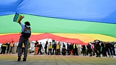 Pro-LGBT demonstrators display a huge rainbow flag as they take part in a protest against hatred towards LGBT people in Warsaw on August 30, 2020.