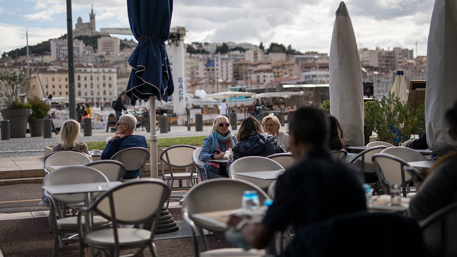 People enjoy refreshments at a restaurant, in Marseille