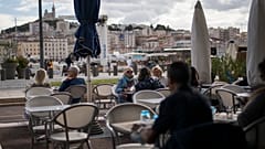 People enjoy refreshments at a restaurant, in Marseille