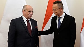 Hungarian Minister of Foreign Affairs and Trade Peter Szijjarto, right, welcomes his Polish counterpart, Zbigniew Rau