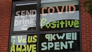 Signs posted on a window at Manchester Metropolitan University's Birley campus.