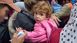 FILE: Refugees arrive at the train station in Saalfeld, central Germany, Sept. 5, 2015. 