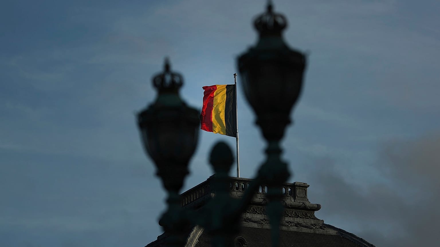 The Belgian flag flaps in the wind on the roof of the royal palace in Brussels.