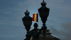 The Belgian flag flaps in the wind on the roof of the royal palace in Brussels.
