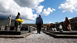 Rev. Mario Carminati walks in a cemetery in Casnigo, near Bergamo, Italy, Sunday, Sept. 27, 2020. 