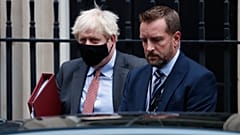 Boris Johnson flanked by his bodyguard leaves 10 Downing Street for the House of Commons.