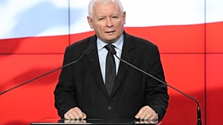The leader of the Polish ruling party, Jaroslaw Kaczynski,center, speaks to reporters in Warsaw, Poland, Saturday, Sept. 26, 2020.