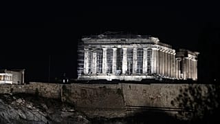 A new lighting system illuminates the ancient Acropolis hill in Athens, Wednesday, Sept. 30, 2020. 