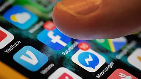 In this Aug. 11, 2019, file photo an iPhone displays the apps for Facebook and Messenger.
