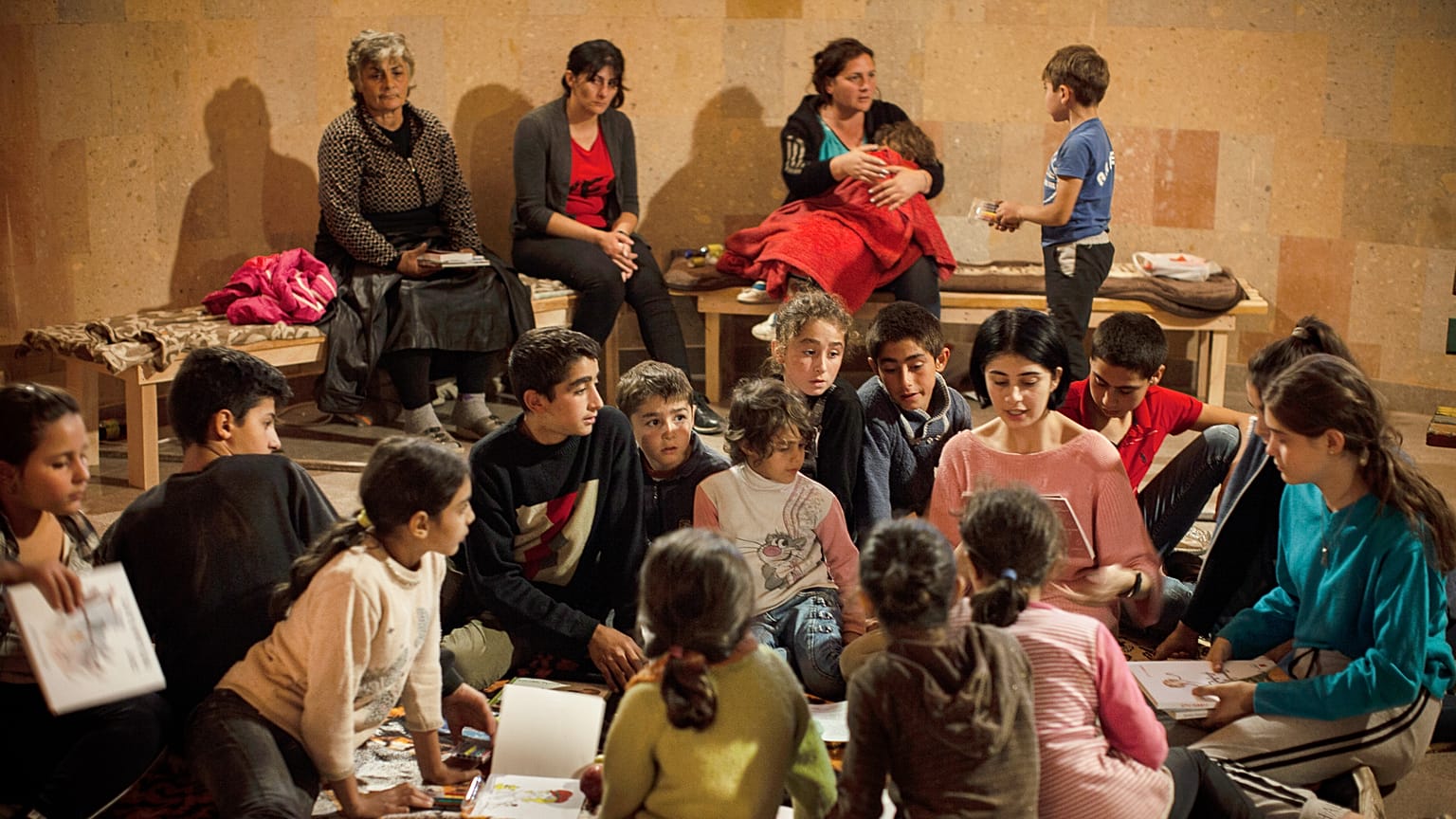 Women and children read books in a bomb shelter as they seek refuge from shelling in Stepanakert/Khankendi, in region of Nagorno-Karabakh. October 1, 2020