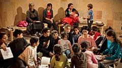 Women and children read books in a bomb shelter as they seek refuge from shelling in Stepanakert/Khankendi, in region of Nagorno-Karabakh. October 1, 2020
