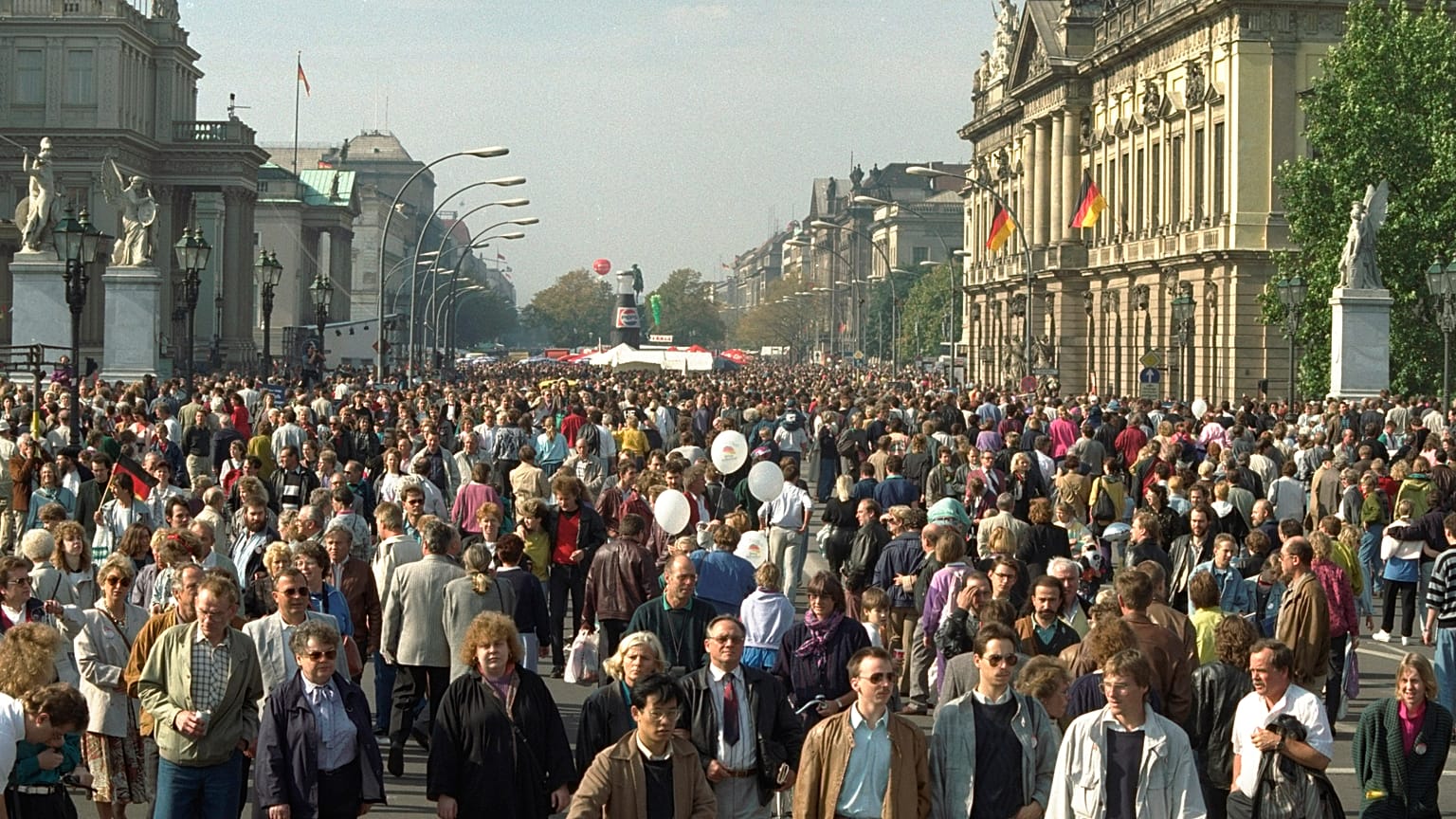October 3, 1990, file photo, Germans stroll along the famous Unter den Linden boulevard in former East Berlin, to enjoy unification day.