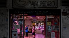 Two customers wearing face masks inside a food market in Madrid