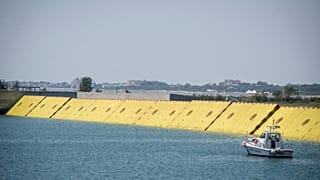 Moveable flood gates rise from the sea in the Venice lagoon, Italy, Friday, July 10, 2020. 