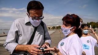 A participant has her oxygen saturation measured, during an event organized by the local medical association, in order to support the use of protective masks, in Greece.