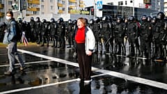 A protester shouts in front of a riot police line during a rally in Minsk, Belarus, Sunday, Oct. 4, 2020. 