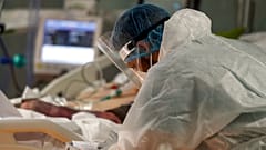 Medical staff of the Intensive Care Unit of the Casalpalocco COVID-19 Clinic in the outskirts of Rome tend to patients.