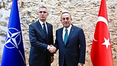 Turkish Foreign Minister Mevlut Cavusoglu, right, shakes hands with NATO Secretary General Jens Stoltenberg 
