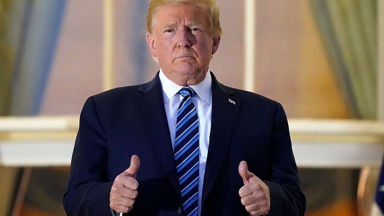 Donald Trump gave a double thumbs up as he re-entered the White House